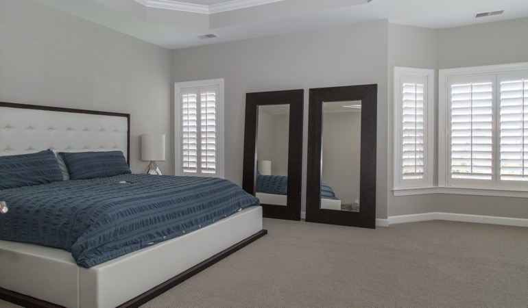 White shutters in a minimalist bedroom in Honolulu.